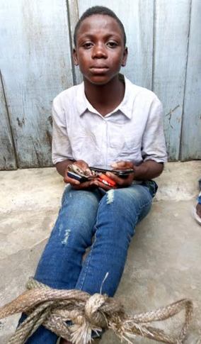 Photos: Young boy caught in Lagos after stealing phones and cash