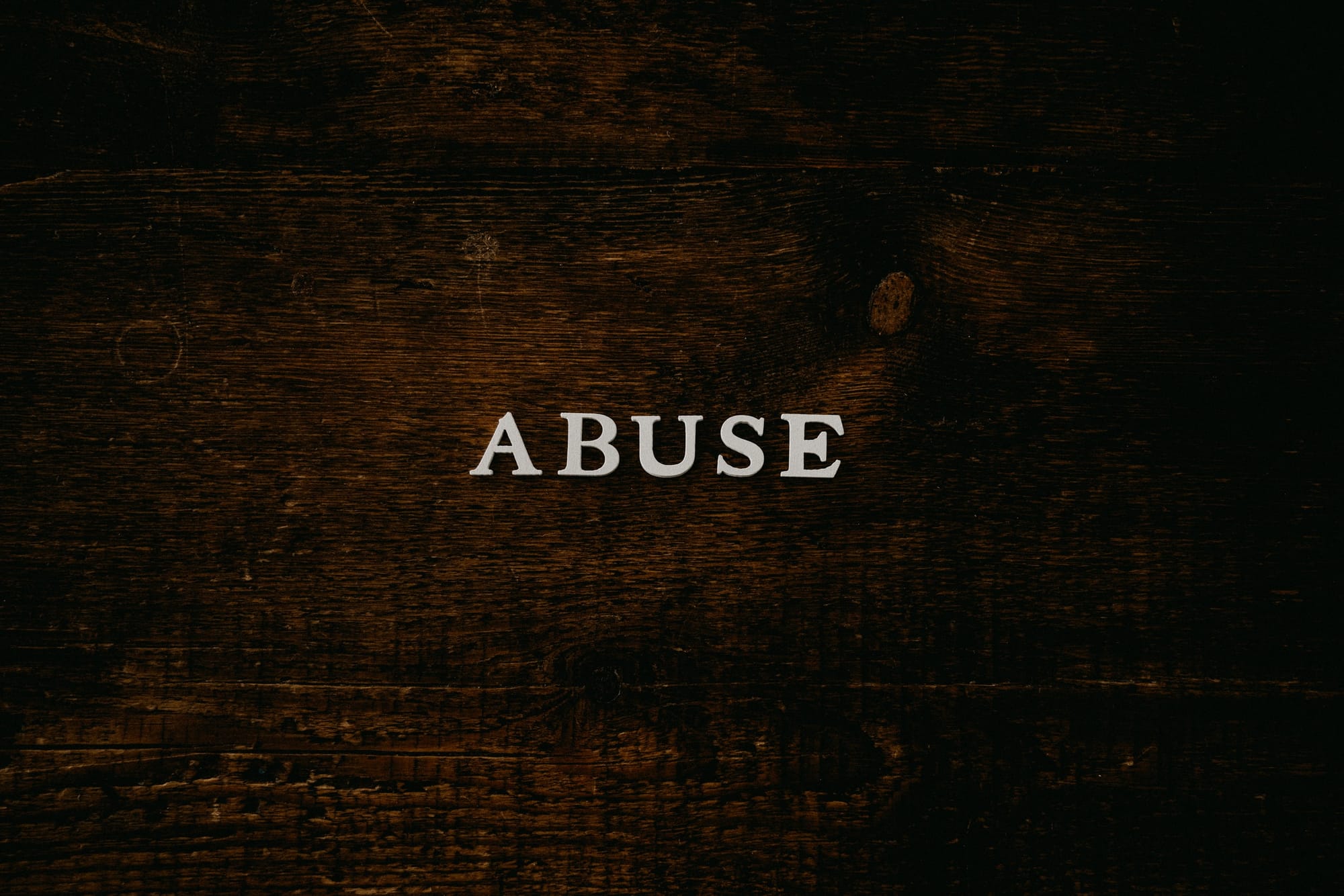 How can repeated exposure to abuse and trauma lead to learned helplessness?