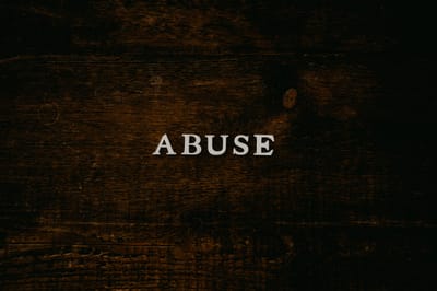 How can repeated exposure to abuse and trauma lead to learned helplessness?