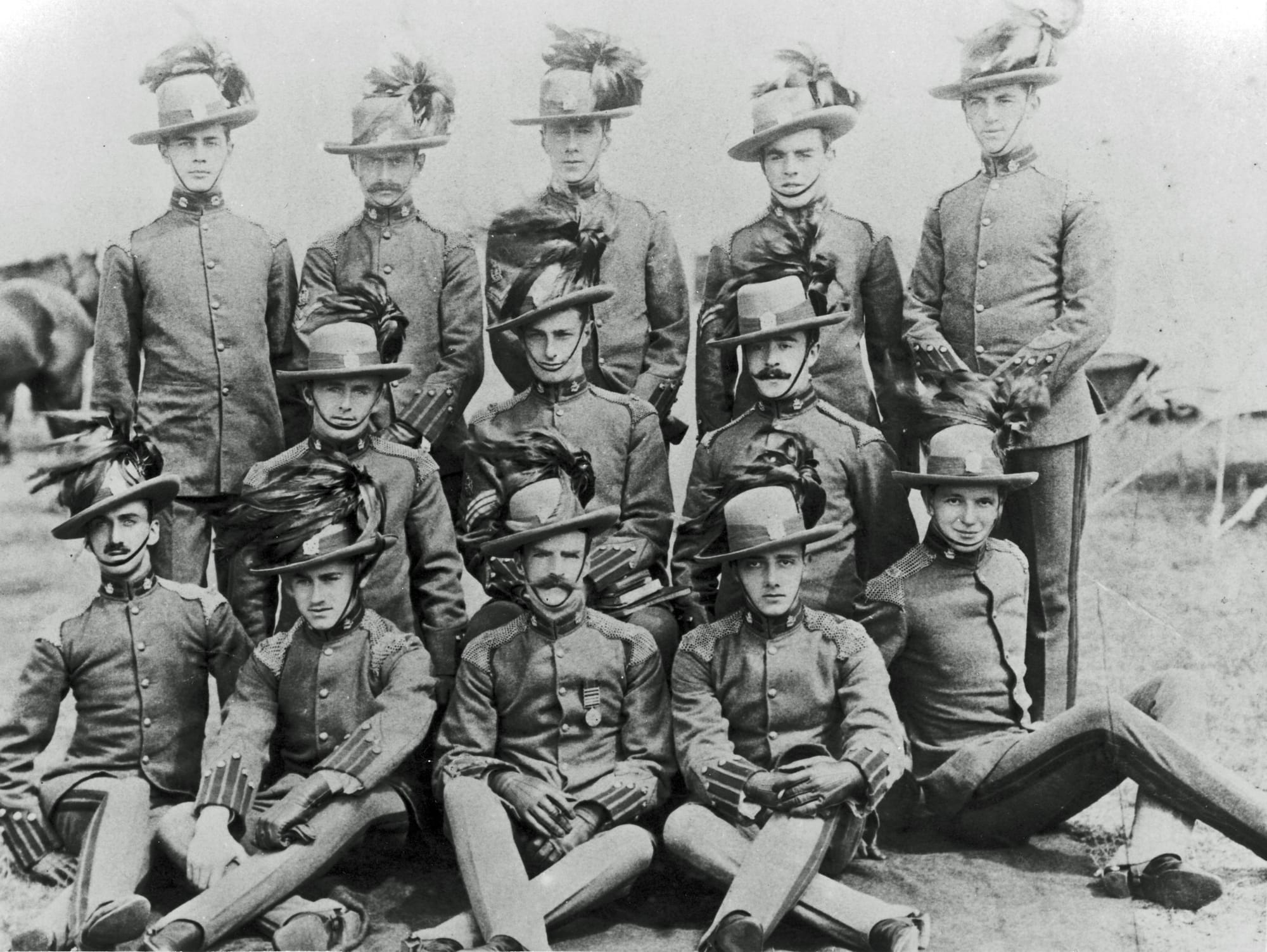 Group photograph of KEH Other Ranks in Full Dress uniform circa 1911 (Courtesy David Knight). They are still wearing 'B' Squadron (British American) collar badges of the King's Colonials with KEH first pattern headdress badges in the Sombrero hat with the brim partially turned up with a sweeping plume of cock’s feathers. Private Basil Rathbone,106 (brother of British actor Basil Rathbone, Captain Basil Rathbone, MC, Liverpool Scottish) is seated to the left hand side, see Nominal Roll for more details.