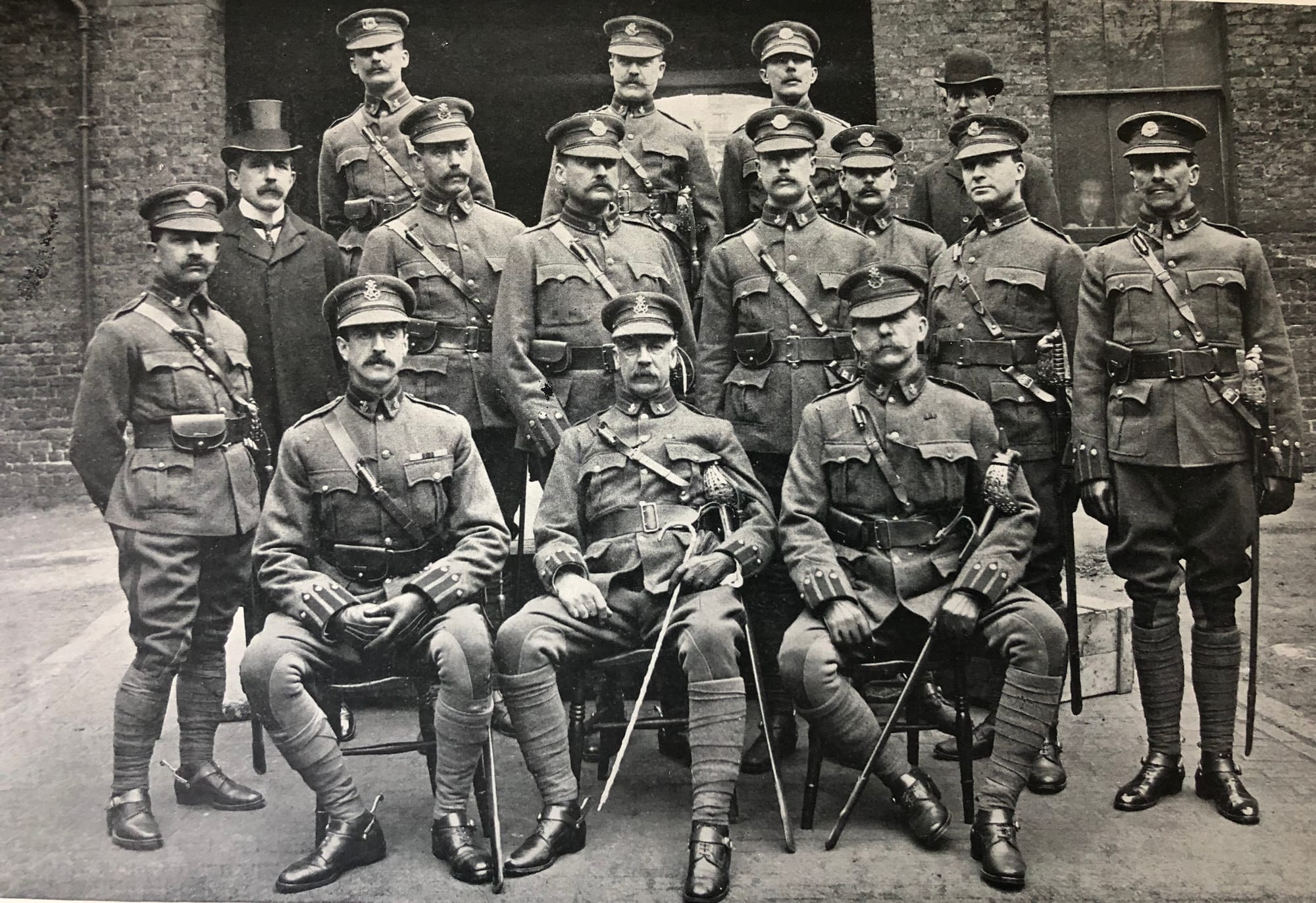 The Officers of the 4th County of London (King’s Colonials) Imperial Yeomanry from left to right, back row: Lieutenant Lionel James, Captain J. Howard, Lieutenant P. Hare and Surgeon-Lieutenant L. J. H Oldmeadow, MD.  Second row: Second Lieutenant H. C. Corlette, Colonel Sir E. W. D. Ward (K.C.H Under-Secretary of State for War), Lieutenant G. Hamilton, Captain Sir Robert Baillie, Bart., Lieutenant A. G. Berry, Second Lieutenant W. J. Ratcliffe, Lieutenant Hamar Greenwood, and Lieutenant G. Seymour Fort. Front row: Major J. M. Vereker, Lieutenant Colonel Willoughby Wallace, and Captain and Adjutant Robert Roland Thompson in Undress uniform circa 1902 (Navy and Army Illustrated. London: Elliot & Fry, Volume XIV: Number 274, 147-148, May 3rd 1902).