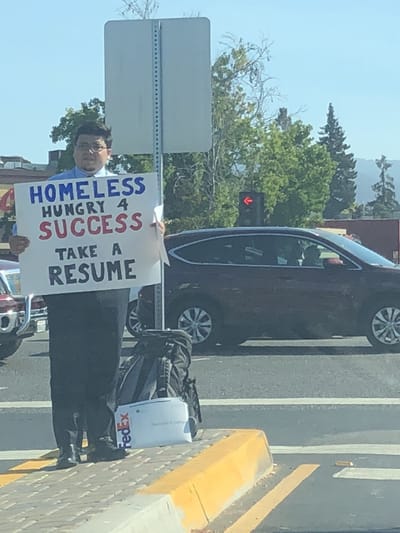 Homeless Man Gets Multiple Job Offers after Photo of him Handing out his Résumè on a Highway Went Viral