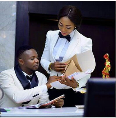 Man Looking At His Wife Behind While Doing Business With Her In Pre-wedding Pics