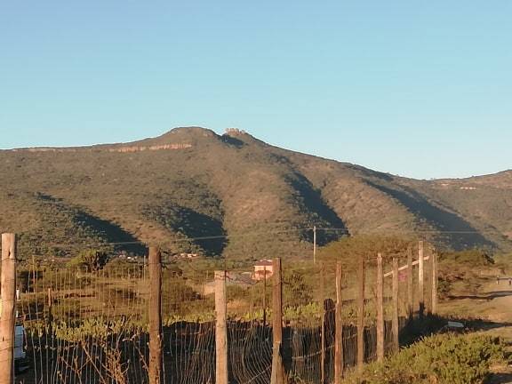 One of the world's few inexplicable wonders of the earth and tourist attraction - Matshemane Mountain with 4 toothlike rocks on its top at the background - Nzala
