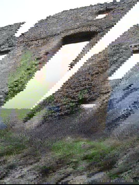 At the window of the ruined house