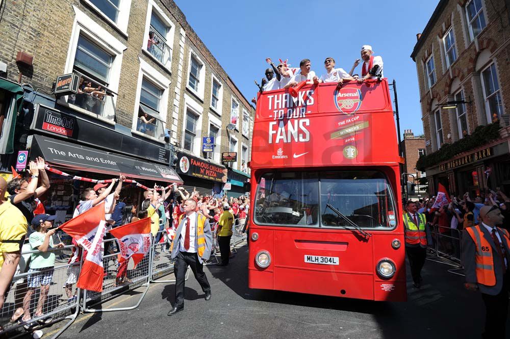 Arsenal Players celebrating with fans on Open Top Bus