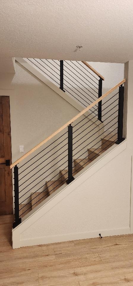 Cable railing with wood top cap.