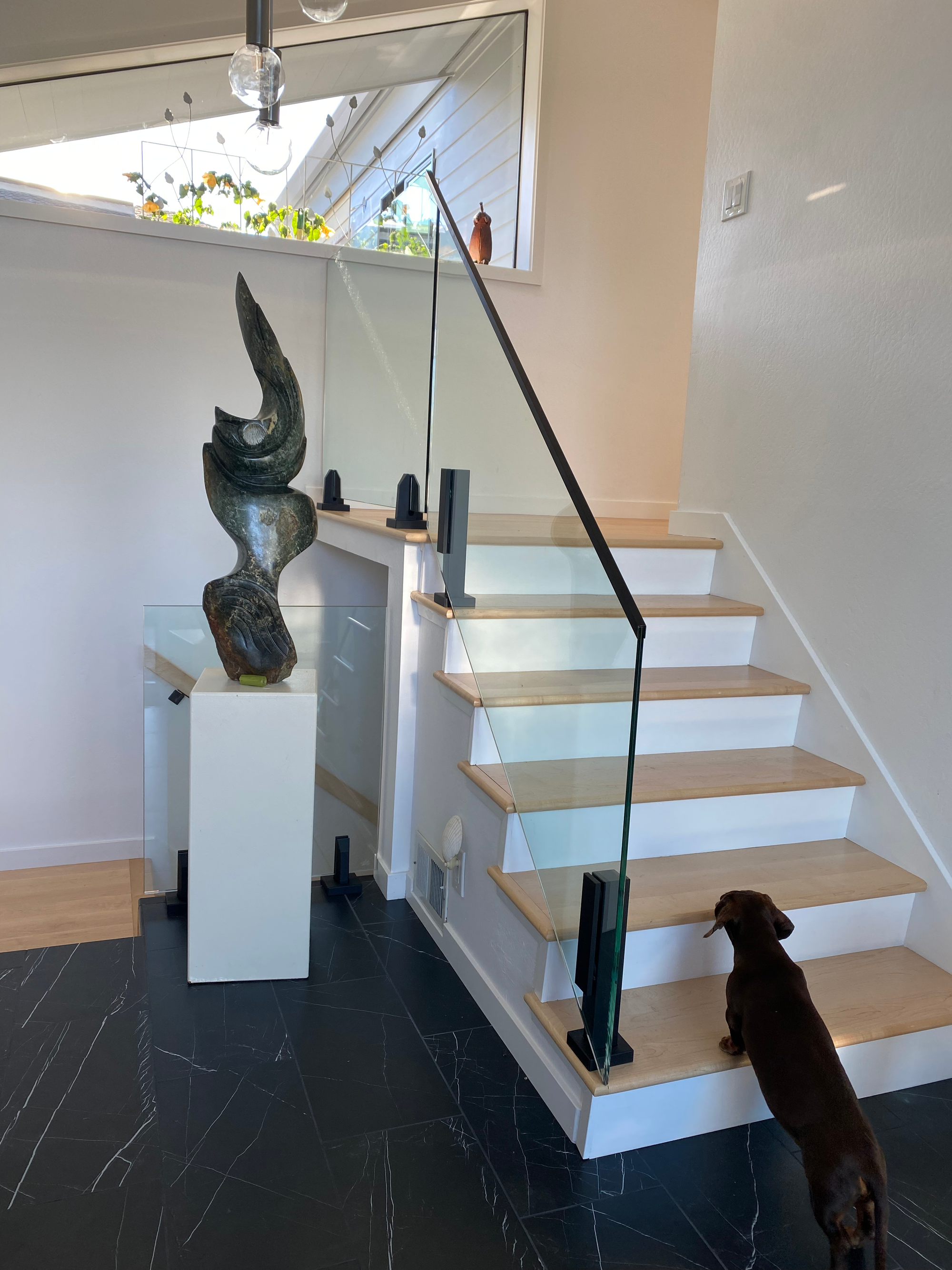 Glass railing with top rail mounted with Standoffs. Matte black finish.