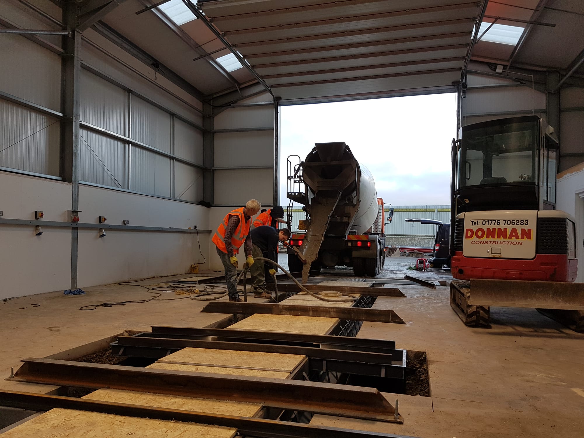 With the pit levelled to existing floor and entrance/exit stair installed, pour concrete.