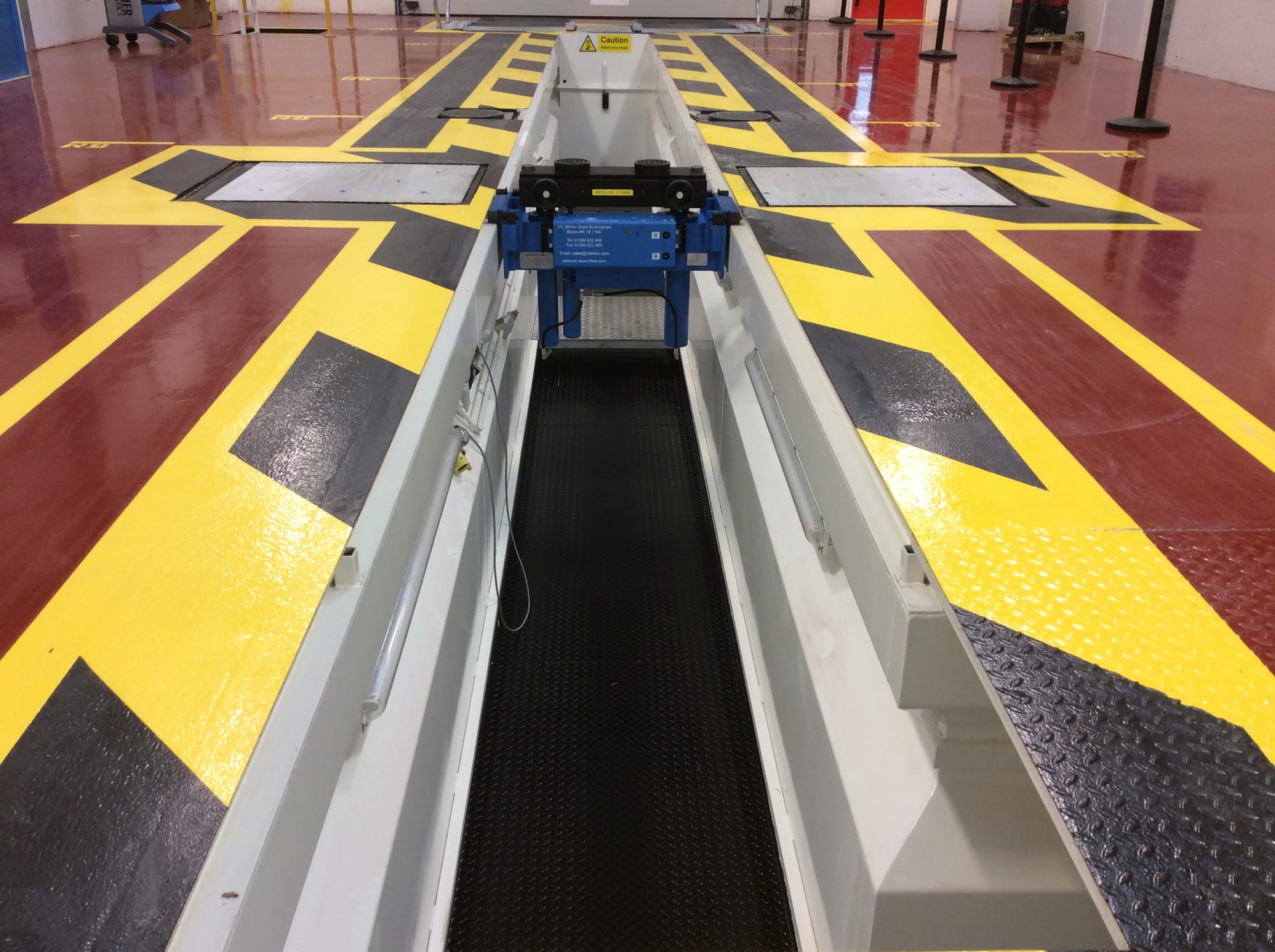 White gloss walls, anti-slip checker plate flooring and full lighting compliment the inspection pit.