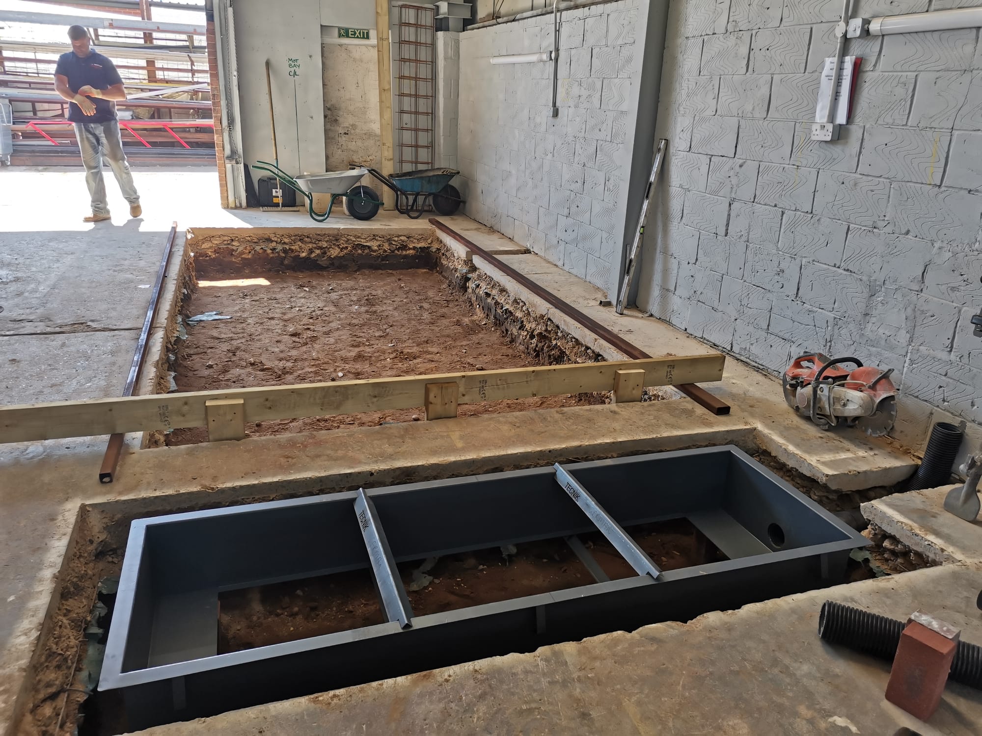 Cut out concrete floor, dispose of spoil.