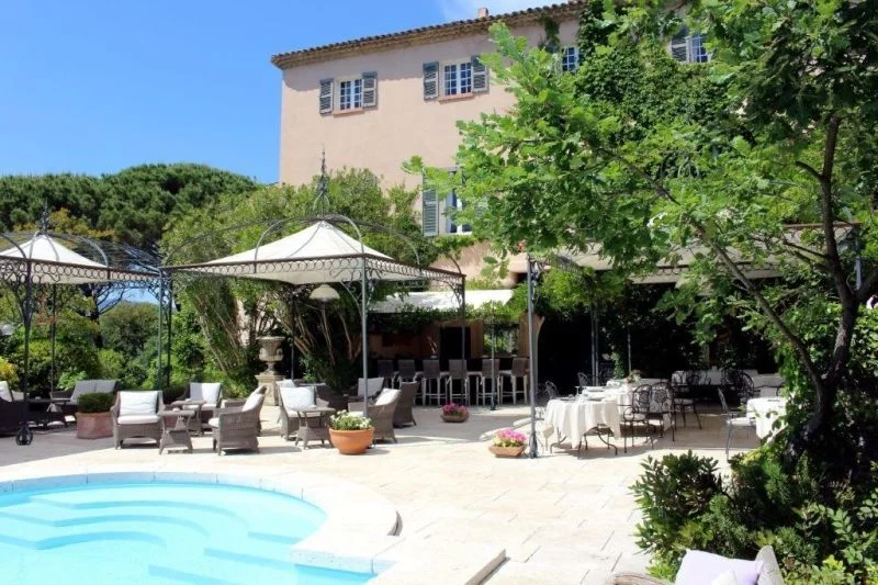 Niché dans un écrin de verdure, l'hôtel et la piscine.