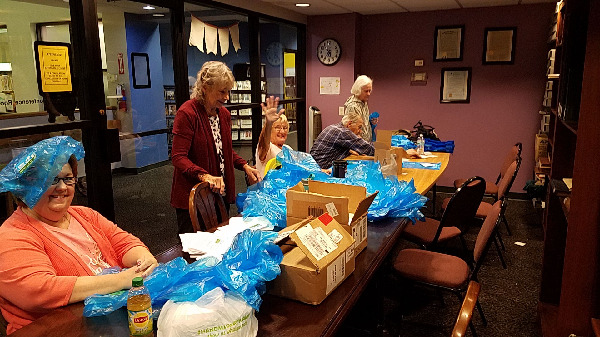 FOL volunteers putting labels on bags for the NPR Library