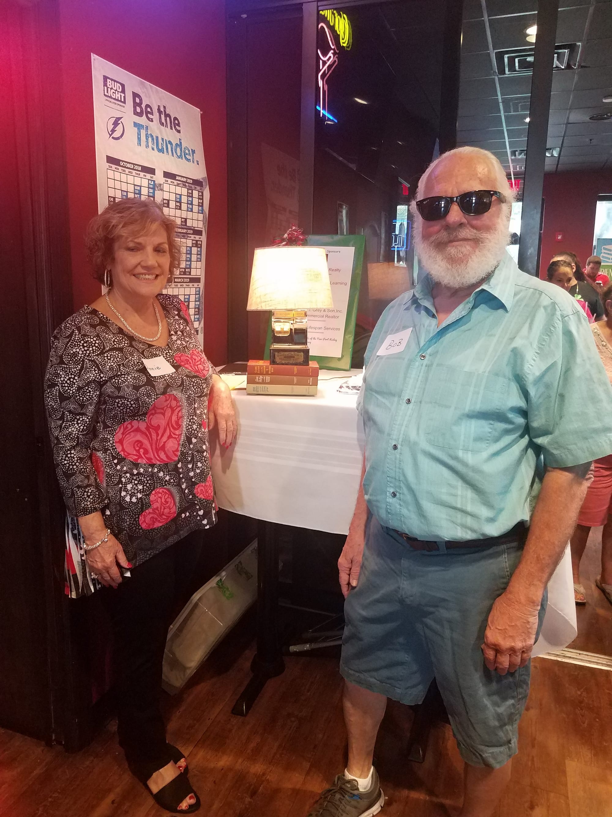 Bob Langford and friend win book lamp at FOL Holiday Party