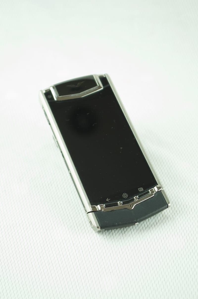 Luxury Vertu Ti mobile phone, cladded in black polished Leather.