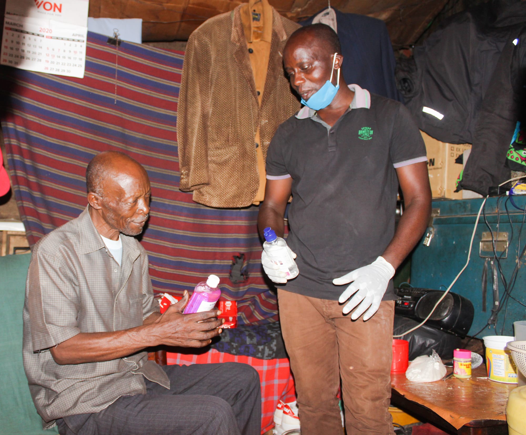 Volunteers donating hand wash and sanitizer to the slum families during COVID-19