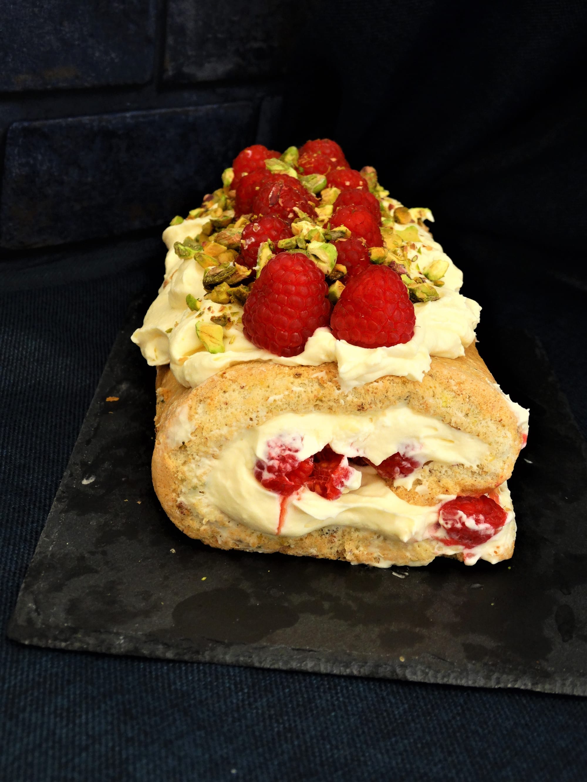 White chocolate and raspberry pistachio roulade