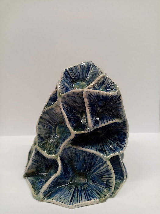Stoneware. Handbuilt with iridescent blue and green glaze colours