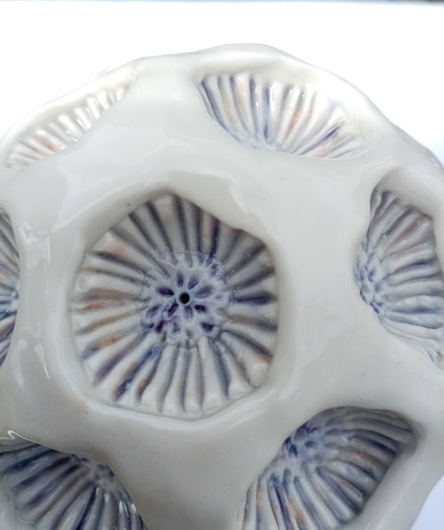 Porcelain. Hand built and glazed with body stains and clear glaze. Approximately 15cm in diameter. 