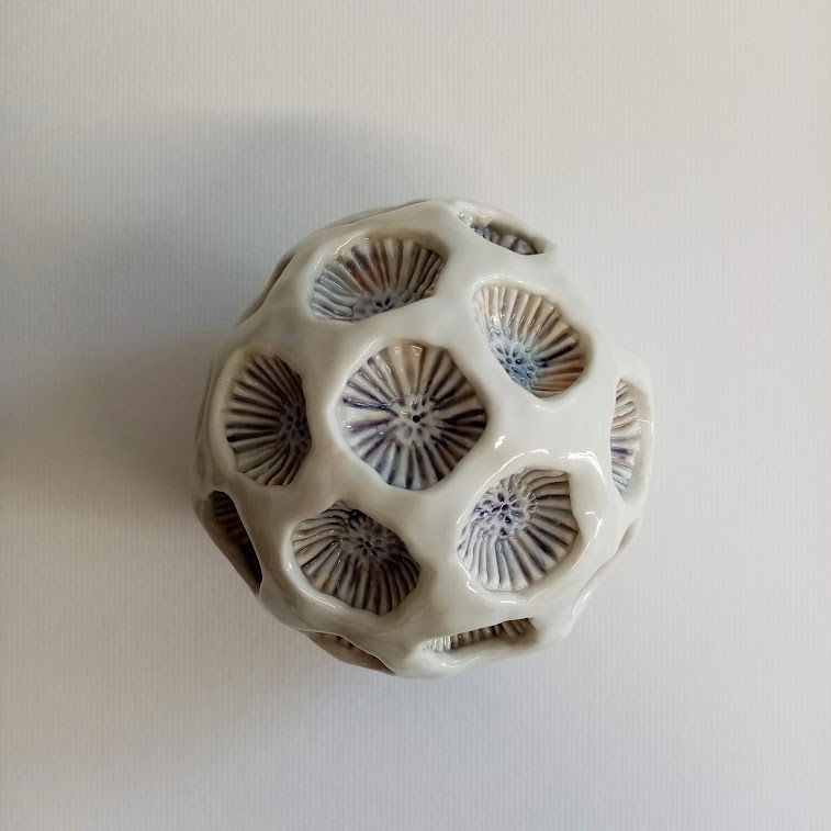 Porcelain. Hand built and glazed with body stains and clear glaze. Approximately 15cm in diameter. 