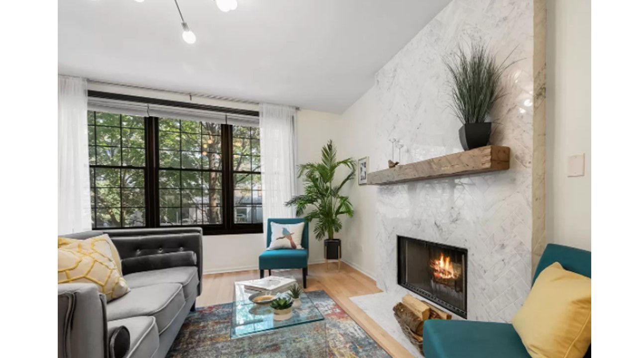 After- this space has become a showstopper with a marble fireplace surround, new paint and pops of color!