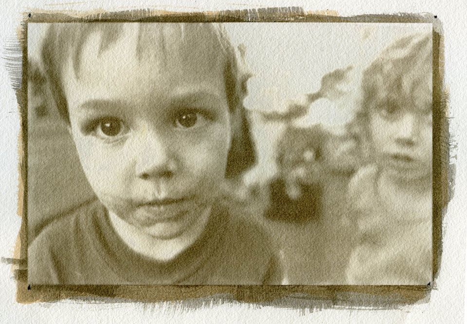 Chocolate covered kid at bus stop. - John Brewer