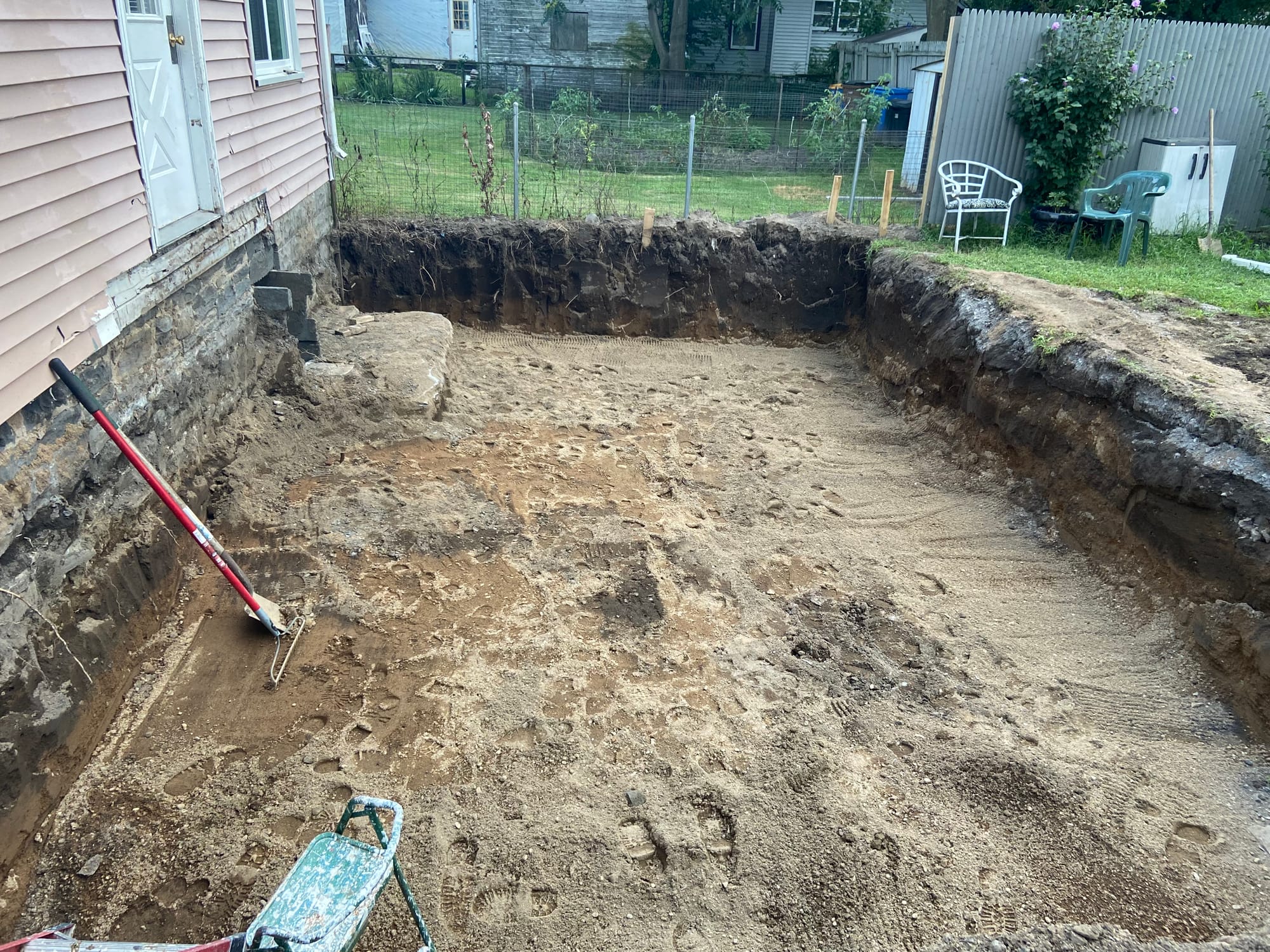 Excavation, footings, walls & waterproofing of a poured concrete foundation.