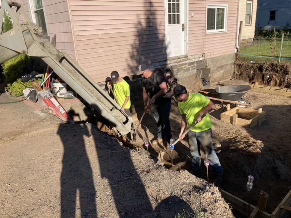 Excavation, footings, walls & waterproofing of a poured concrete foundation.