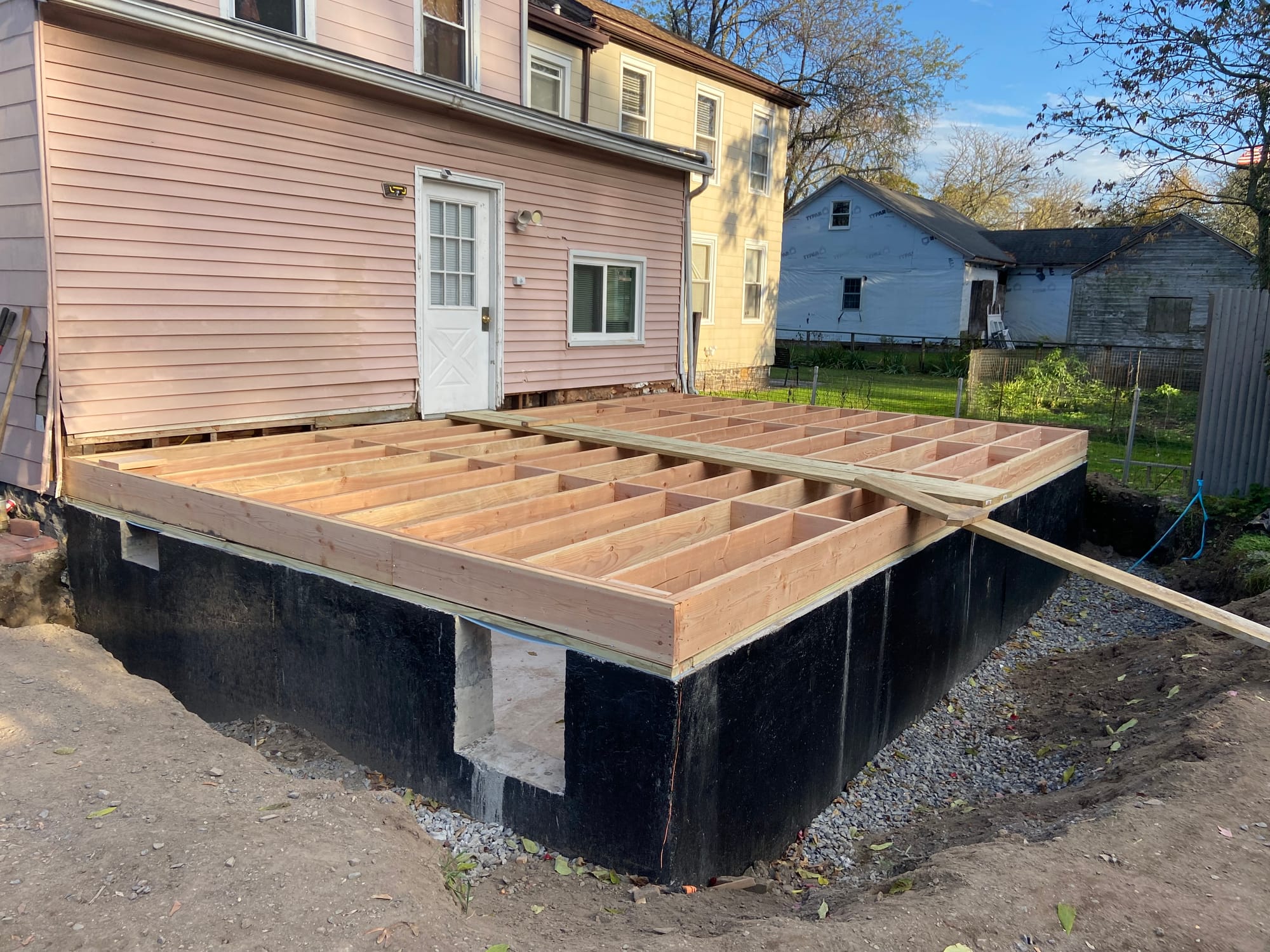 Excavation, footings, walls & waterproofing of a poured concrete foundation.
