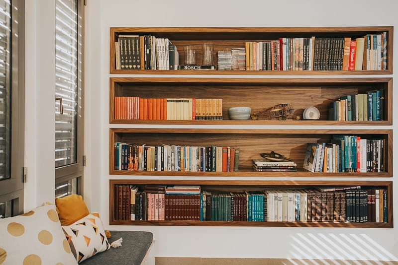 מדפי ספרים שקועים מובנים ומושב קריאה מרופד