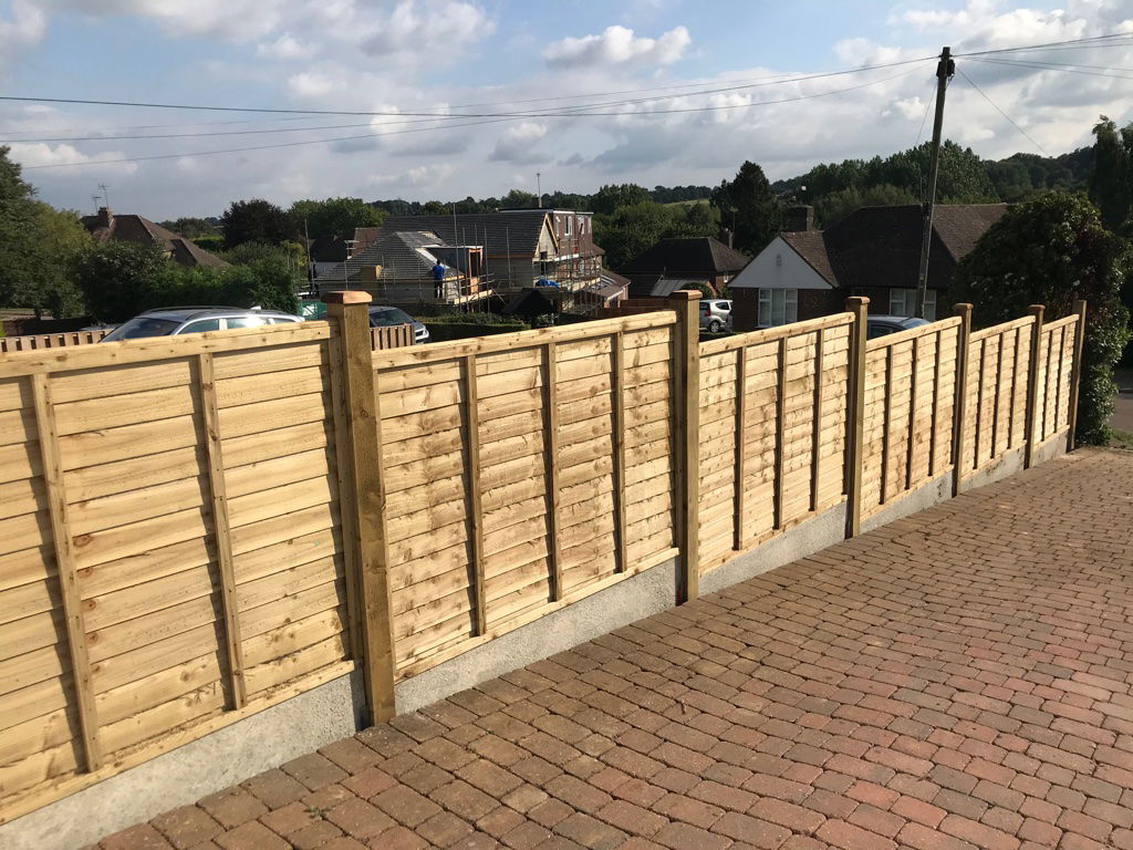 Sloped fencing by driveway