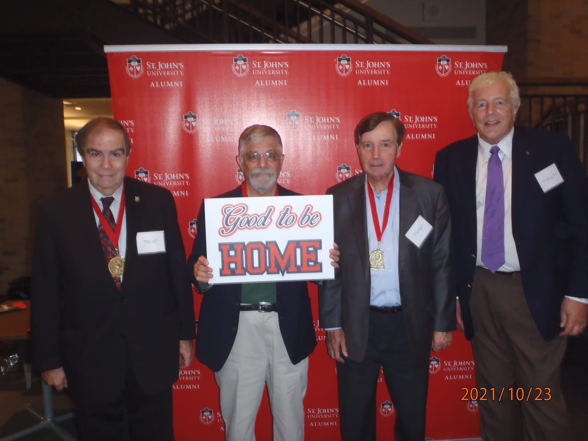 My three fellow alumni and I