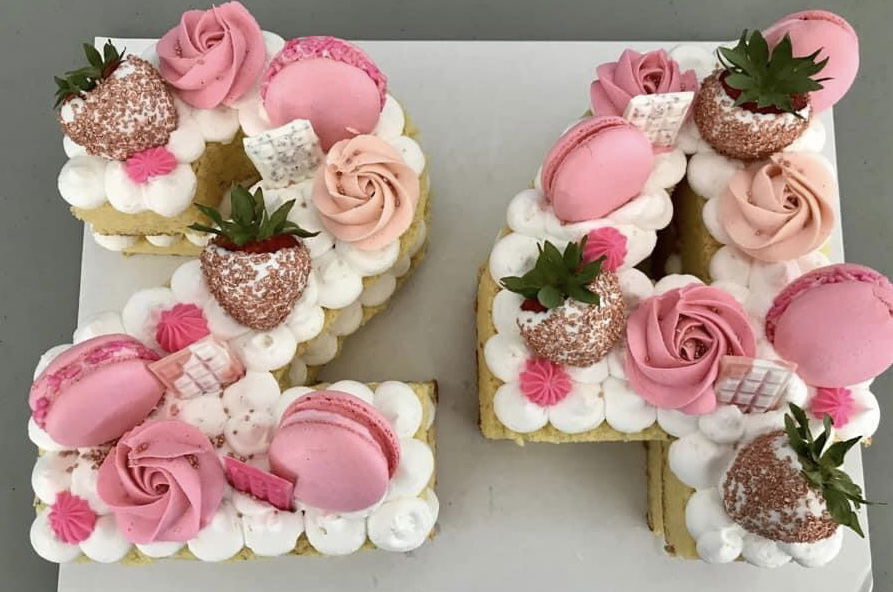 Number 24 Vanilla Cake With Buttercream Frosting, Macarons, and Fresh Strawberries