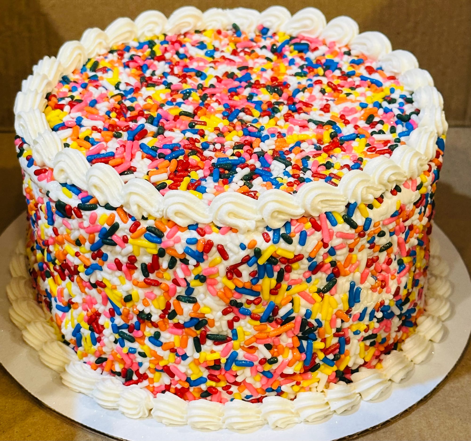 2 Layer Funfetti Smash Cake with Sprinkles Cored Inside and Buttercream Frosting