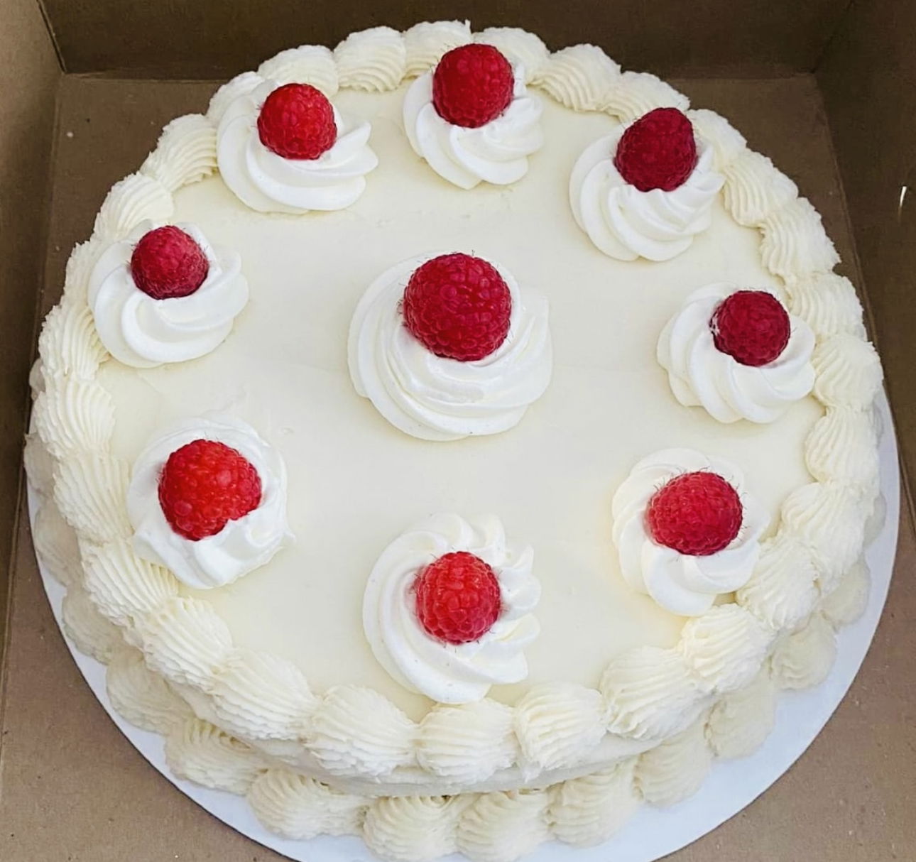 2 Layer Vanilla Cake with Raspberry Filling, Buttercream Frosting, and Fresh Raspberries
