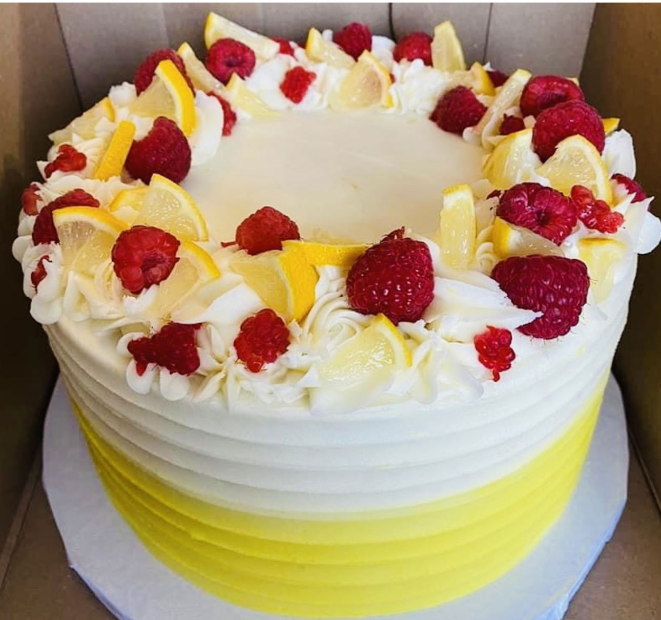 2 Layer Raspberry and Lemon Cake with Buttercream Frosting and Fresh Lemon and Raspberries