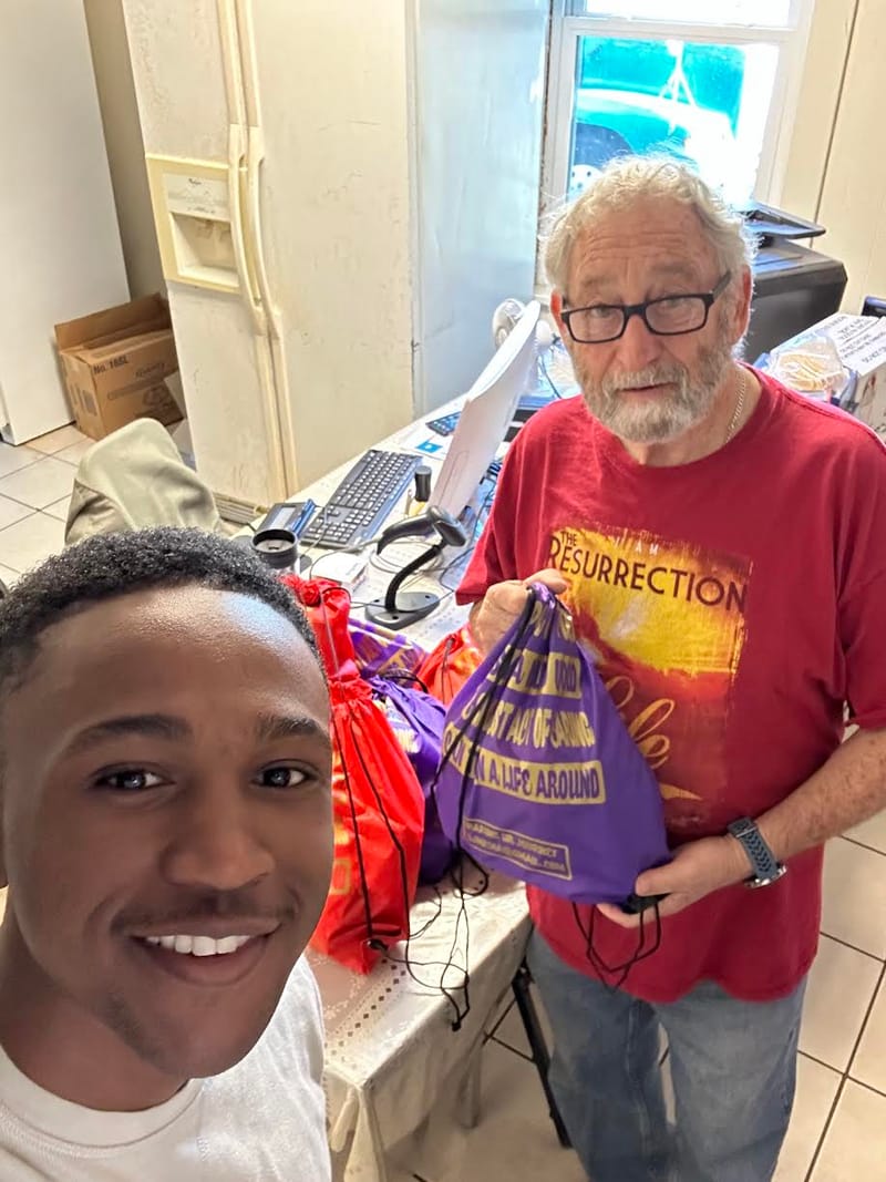 Marcus donates women's bags to The Extended Hand Ministries.