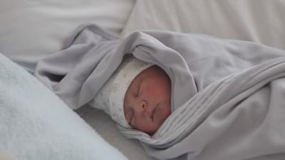 Swaddling a New Born Child  image