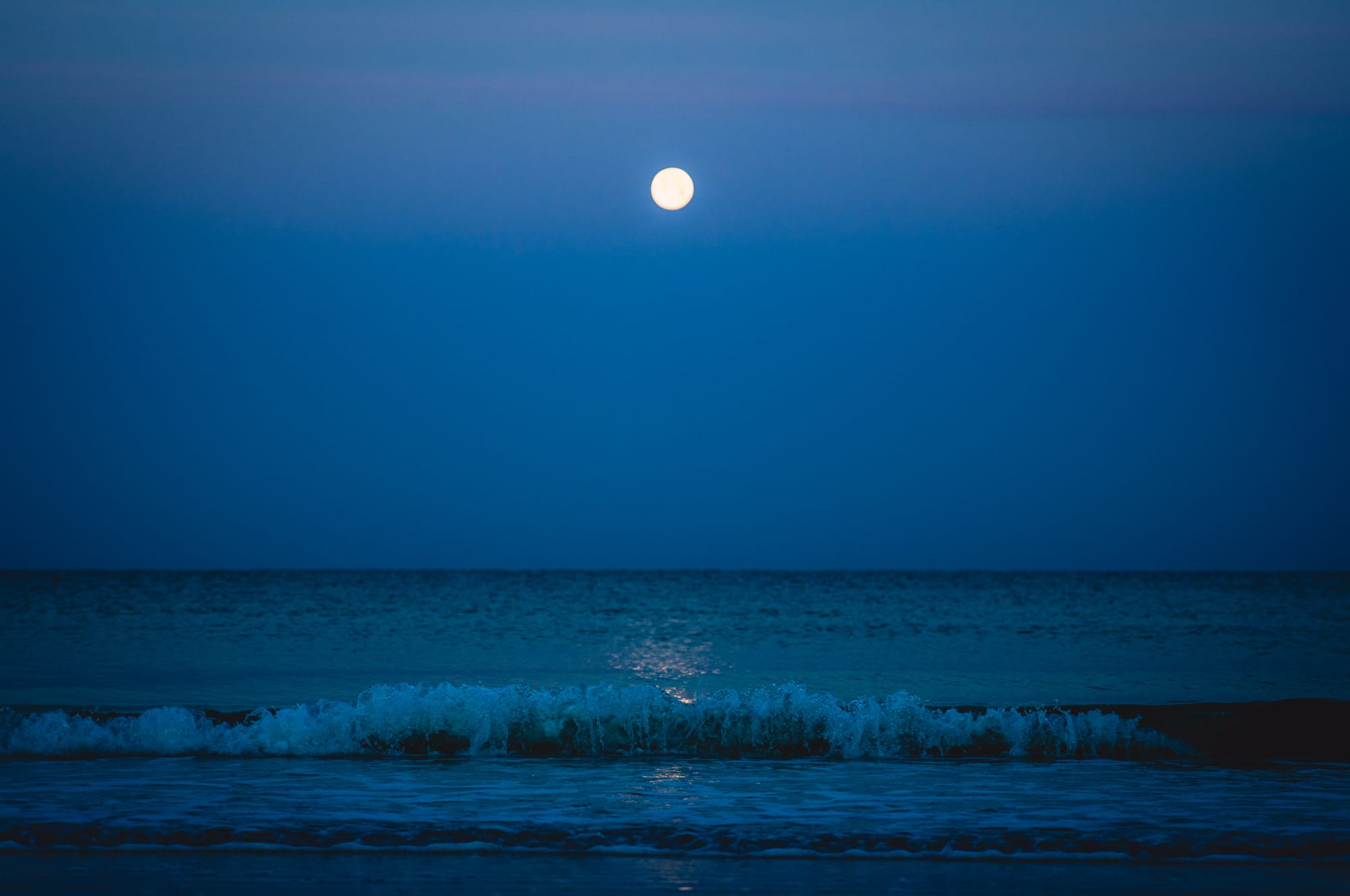 SUNRISE OVER QUIET BLUE OCEAN IN MARCO ISLAND, FL