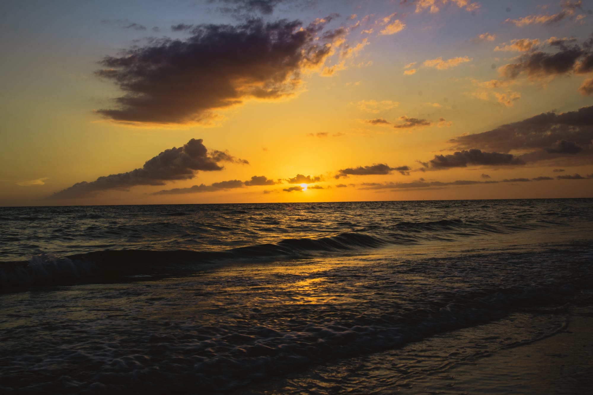 COLORFULL SUNSET OVER THE OCEAN IN MARCO ISLAND, FL