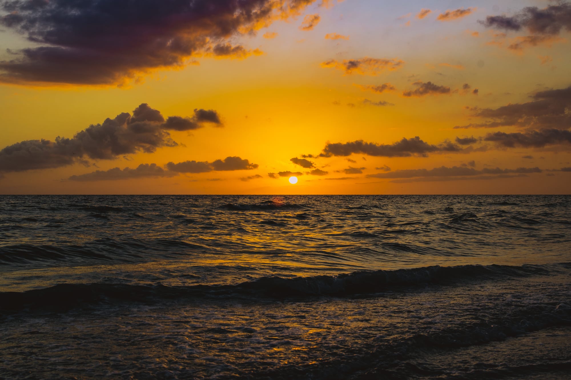 COLORFULL SUNSET OVER THE OCEAN IN MARCO ISLAND, FL