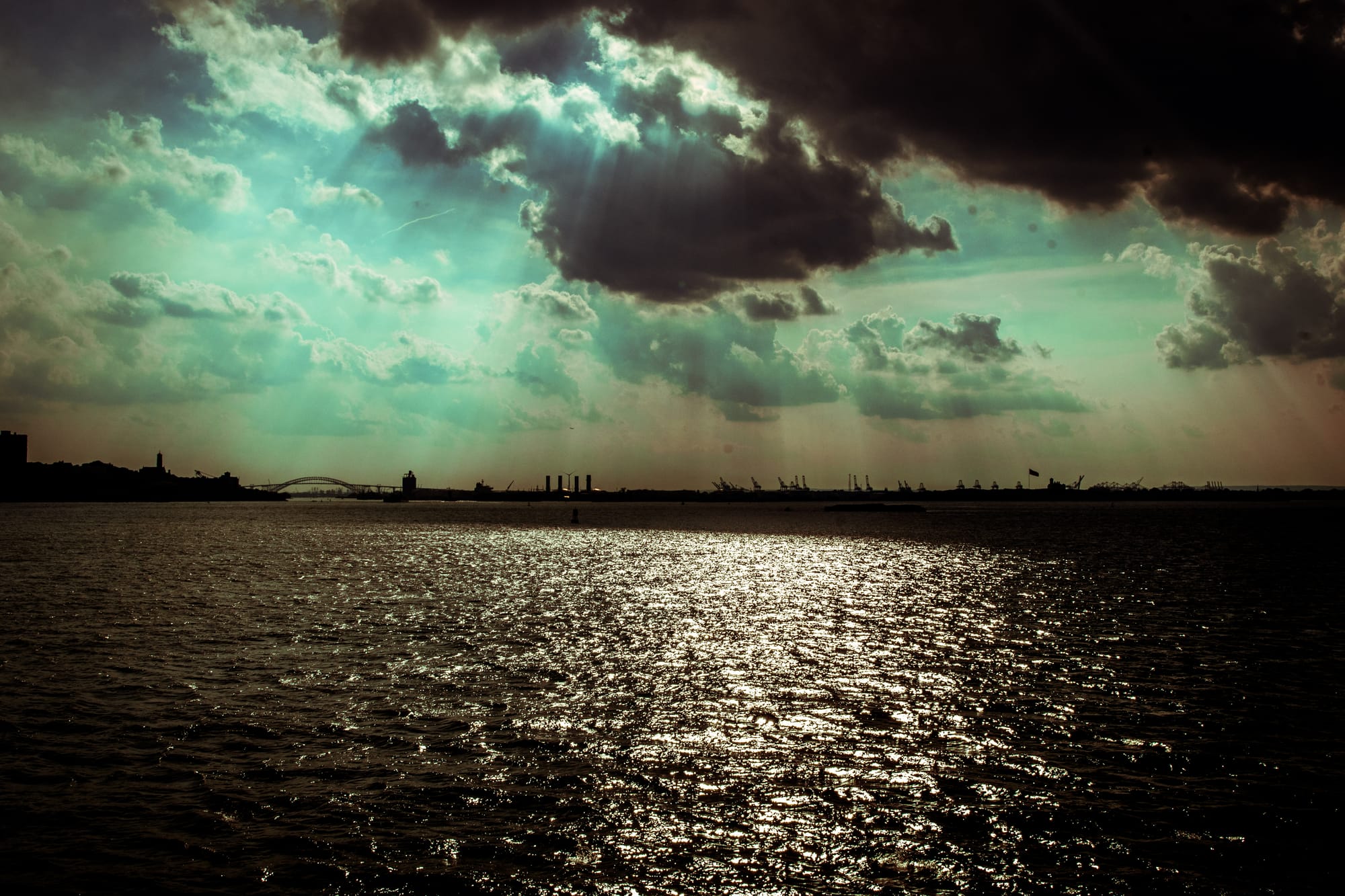 THE RAYS OF THE SUN THROUGH THE CLOUDS OVER HUDSON RIVER, NY