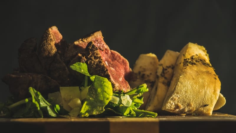 BIG GIRL STEAK - 300 Grams marinated Sirloin, served with Arugula, Parmesan Cheese, Garlic Bread and Balsamic Reduction.  22.80 €