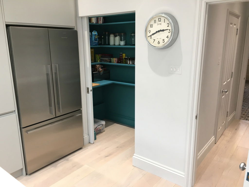 Walk in larder with pocket sliding door built into the kitchen design in this Wandsworth kitchen extension.h