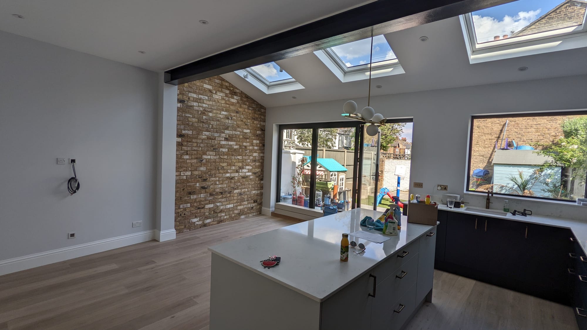 Southfields SW18 kitchen extension with brick slips, exposed steel and bi-fold doors.