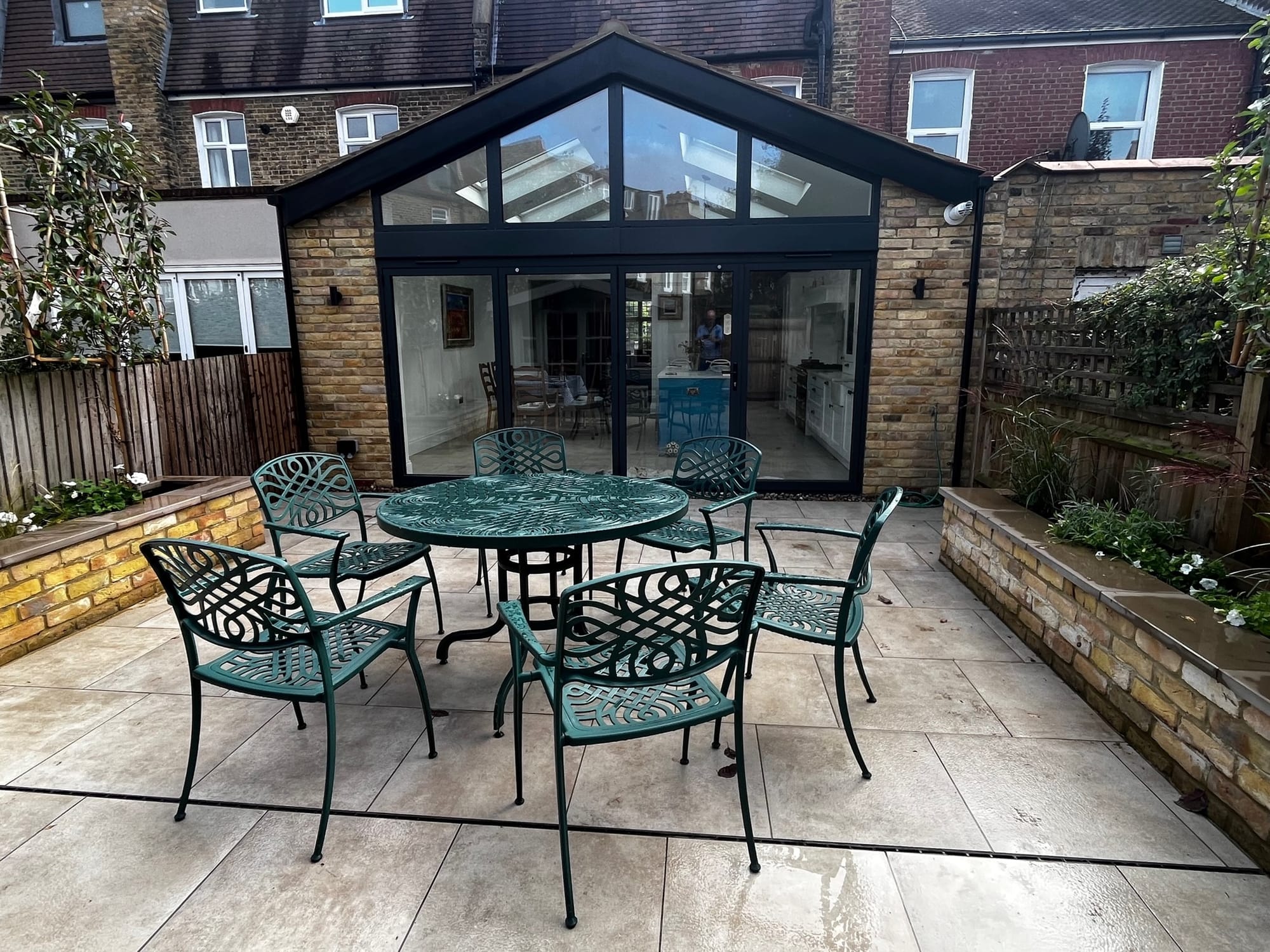 Southfields SW18 kitchen extension with glazed gable, bi-fold doors, patio and brick planters