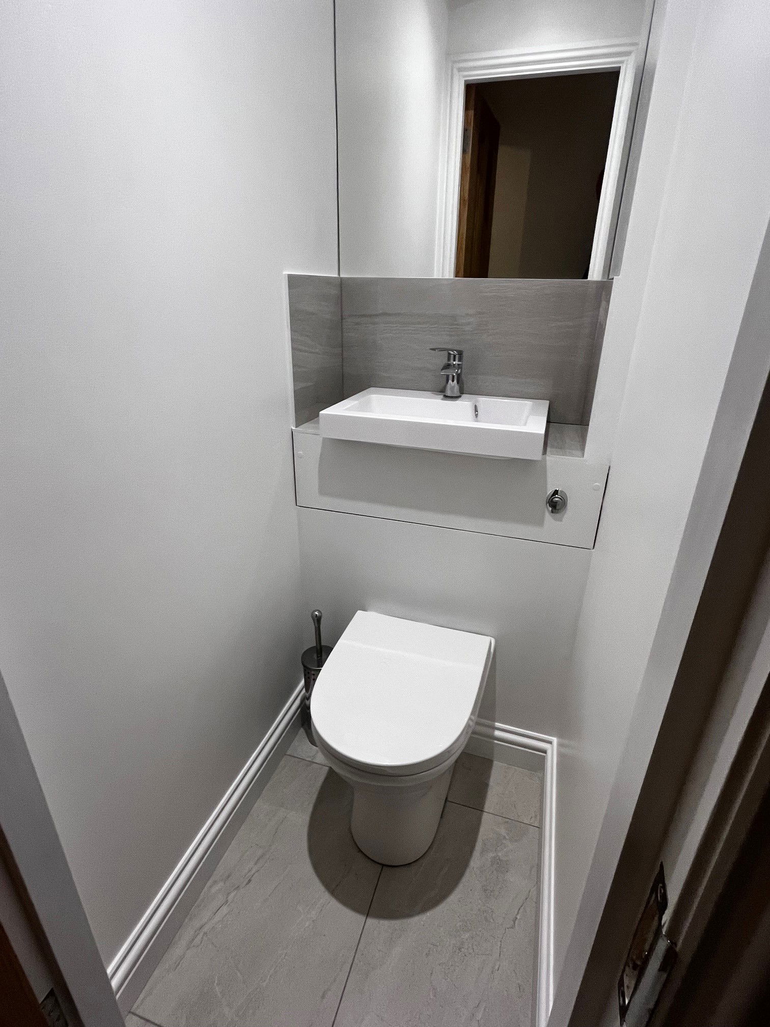 Clever combined loo and basin cistern allowed for an understairs cloakroom and separate utility as part of this SW18 Wandsworth kitchen extension and refurbishmentsmallest room in the house