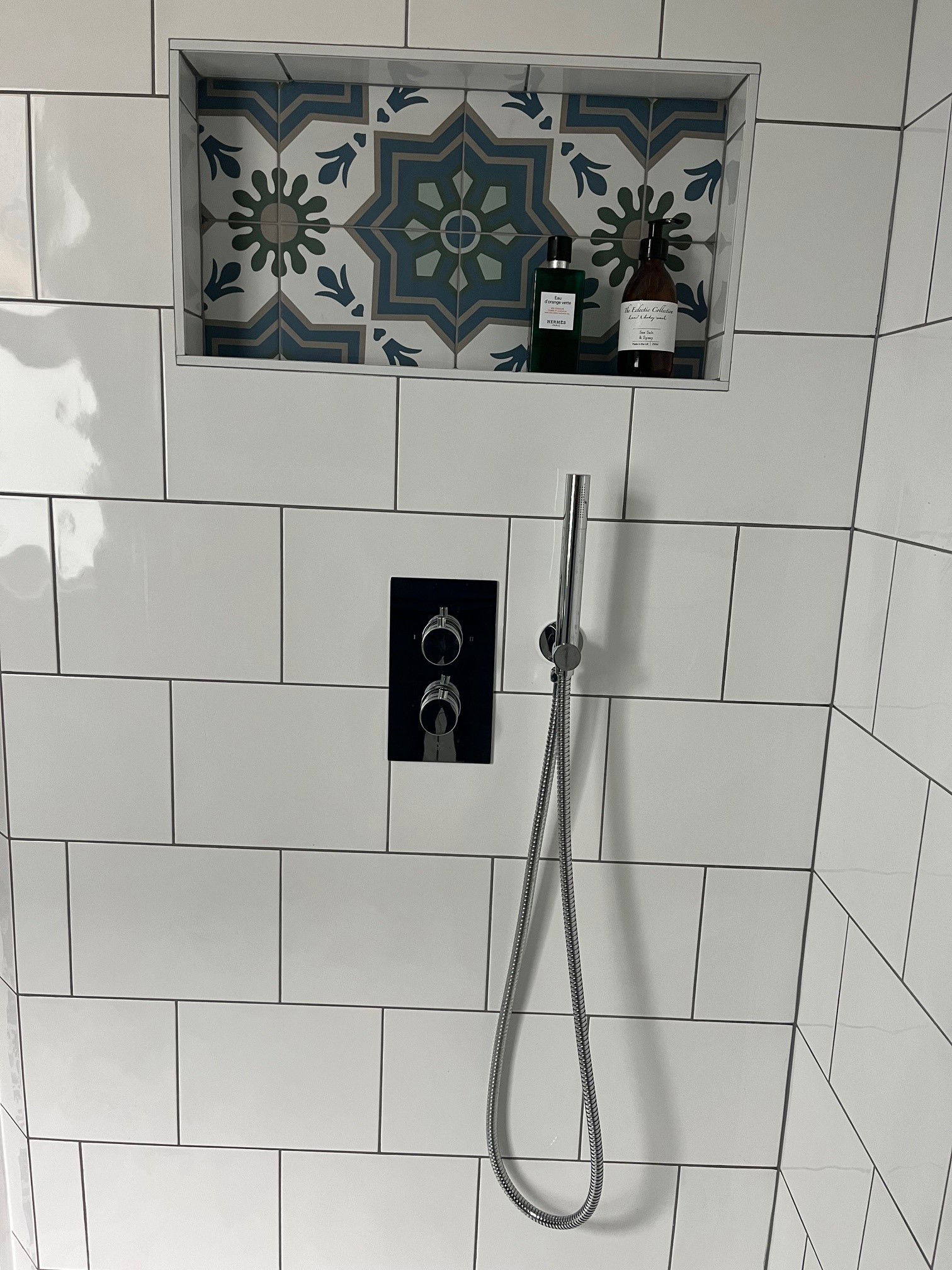 Feature tiles backing a niche in this shower completed as part of a kitchen extension and refurb in Wandsworth SW18