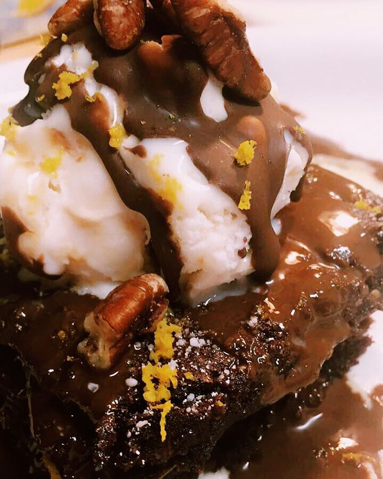 Brownies with vanilla ice cream, chocolate syrup, and  Orange Zest