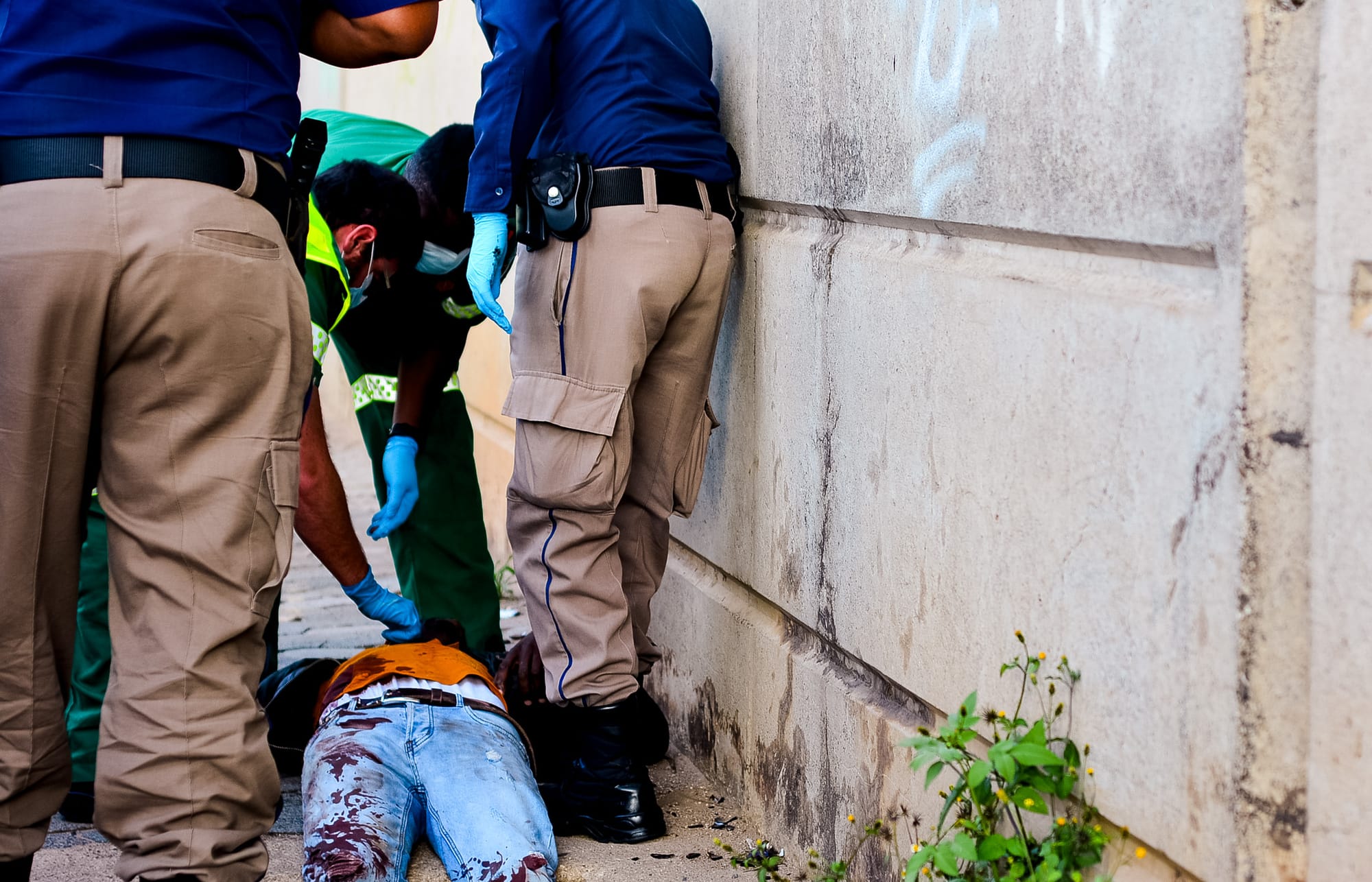 Paramedics and Traffic police attend to an injured suspect